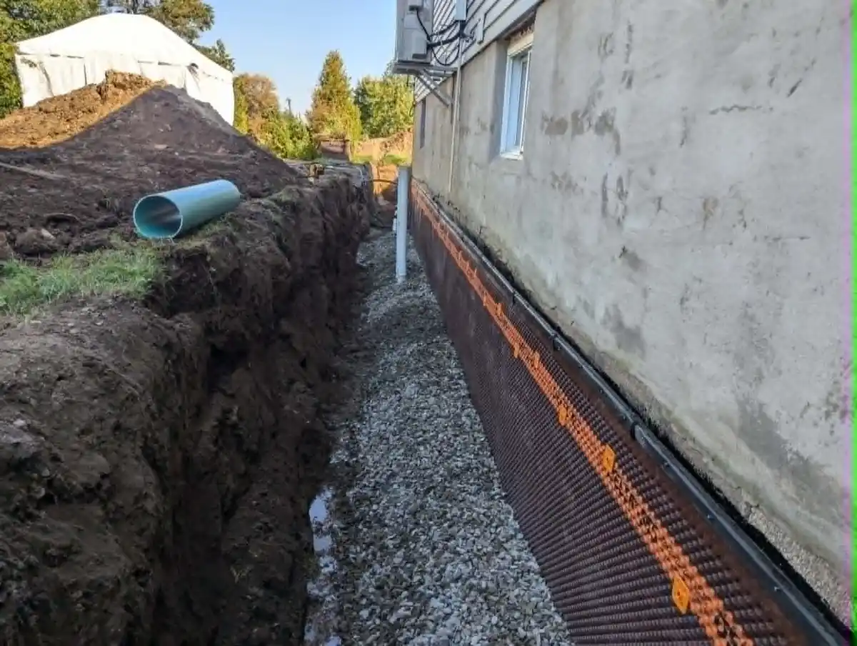 Installation de drain français avec lit de gravier le long d’une fondation
